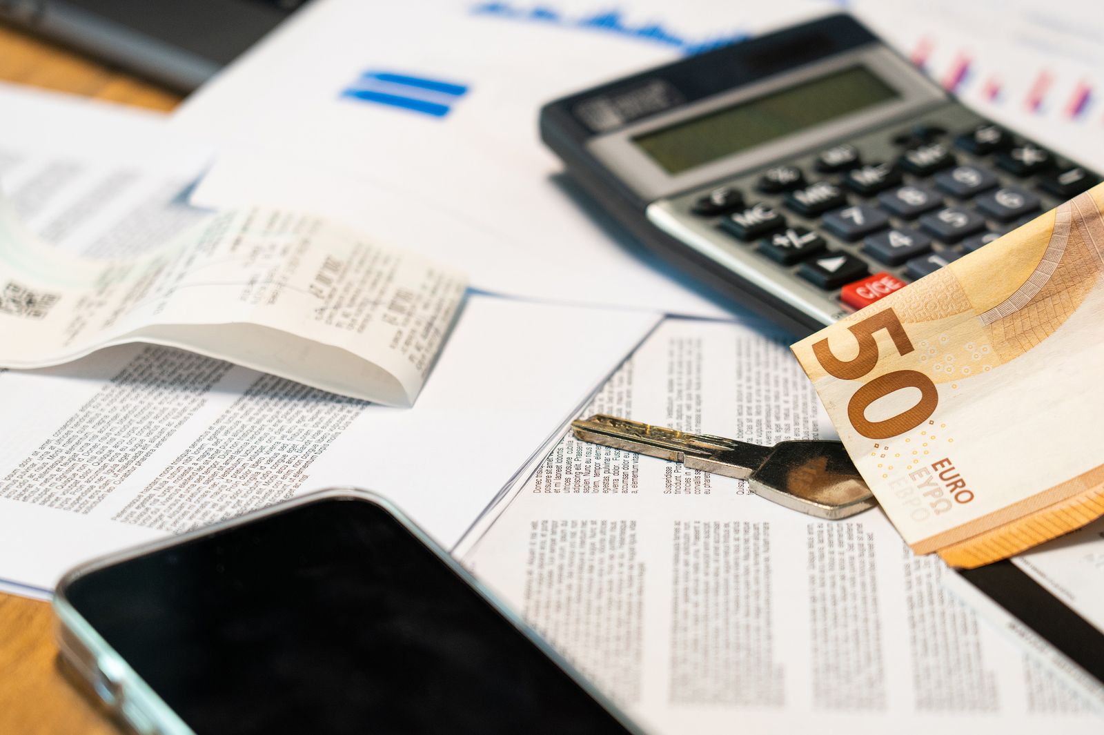 Banconote in euro, calcolatrice e documenti su una scrivania